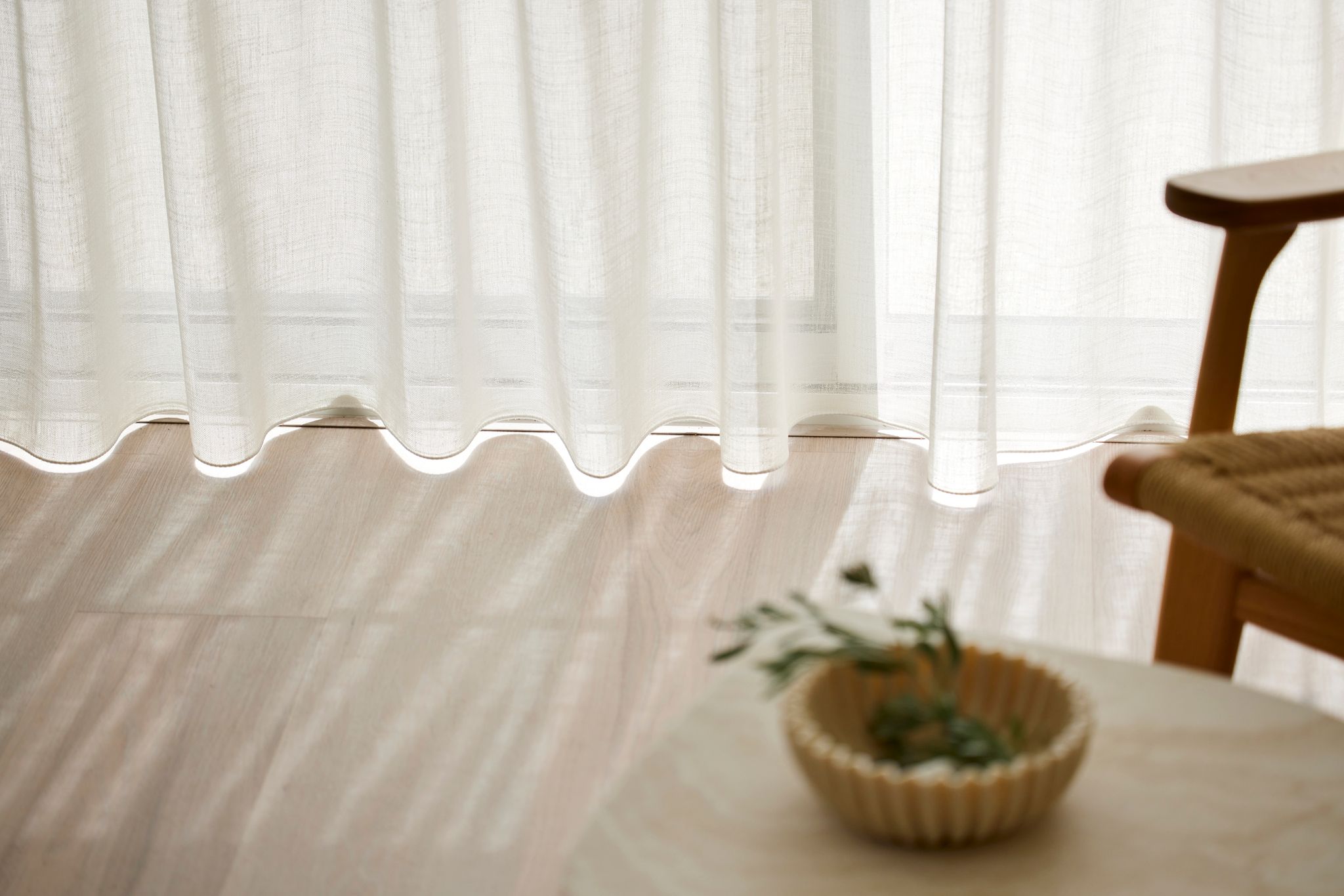 Wave Fold Sheer Curtains gently floating above the floor, with natural outside light coming through