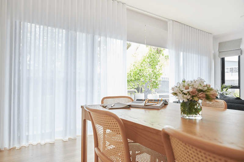 White Sheer Curtains with Blockout Roller Blinds layered underneath in a living and dining area