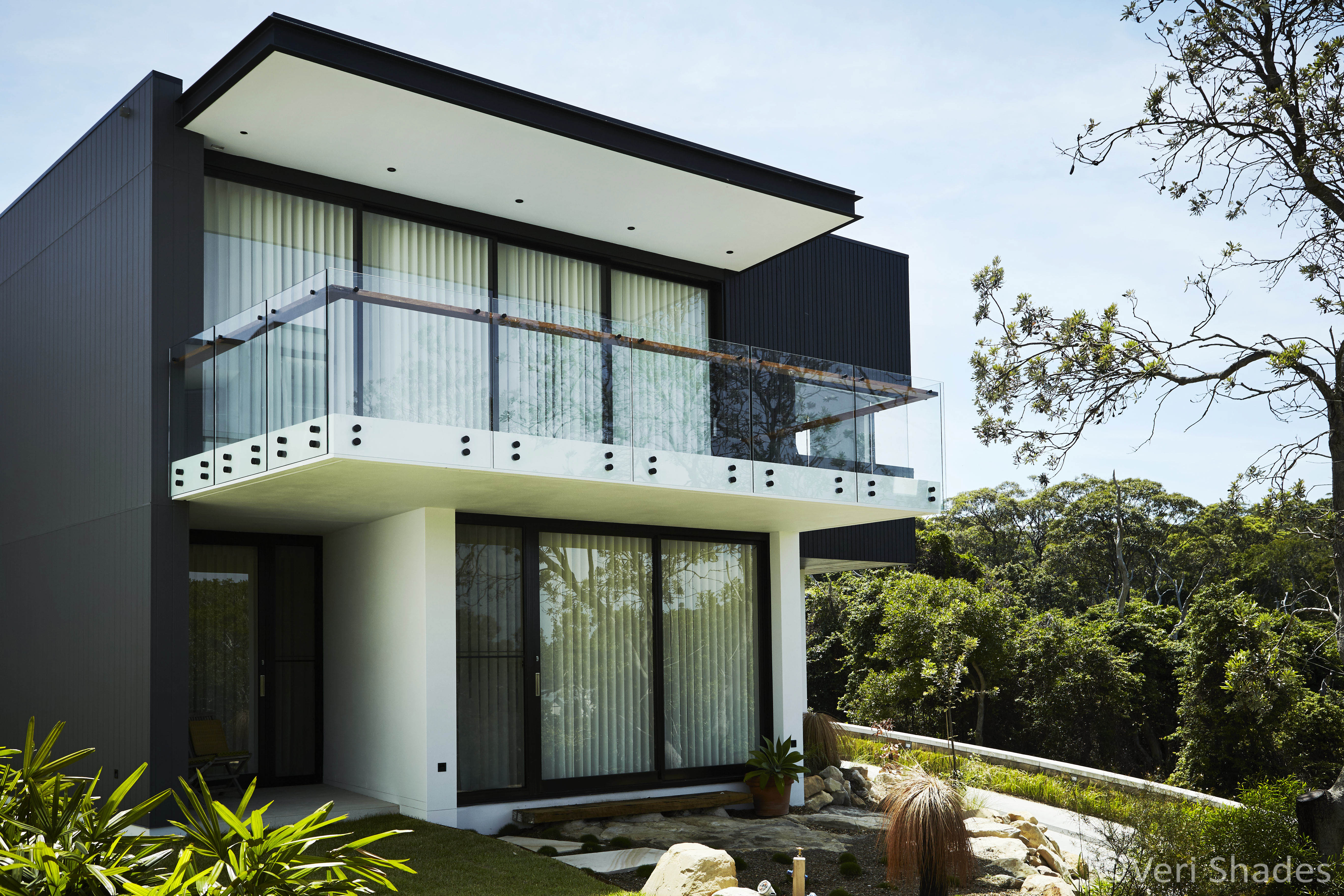 Off-white Veri Shade Blinds shown from the outside exterior of a modern home